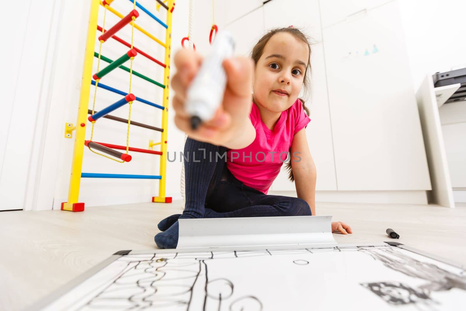 little girl writing on the white board, schooling background.