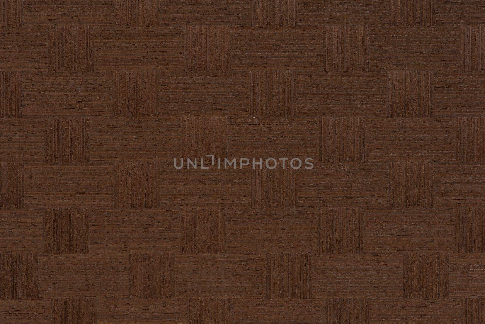 Texture of wenge wood. Dark brown wood for furniture or flooring. Close-up of a Wenge wooden plank, top view. Wenge is pasted over with squares for making furniture
