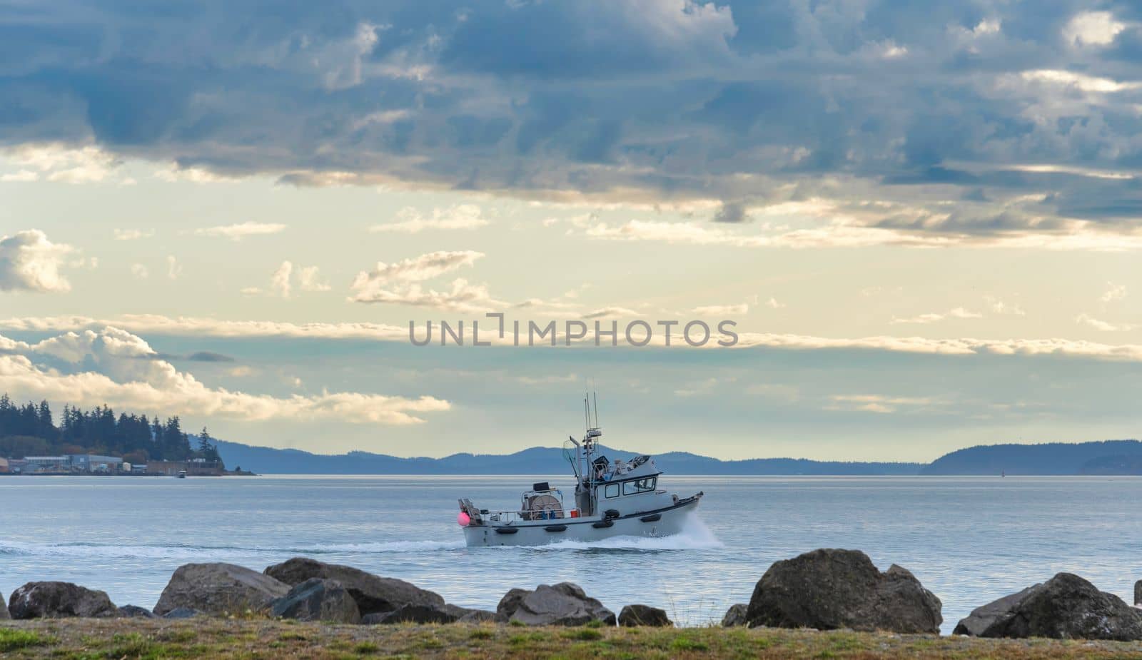 Small trawler is going to the fishing reid in Pacific ocean.