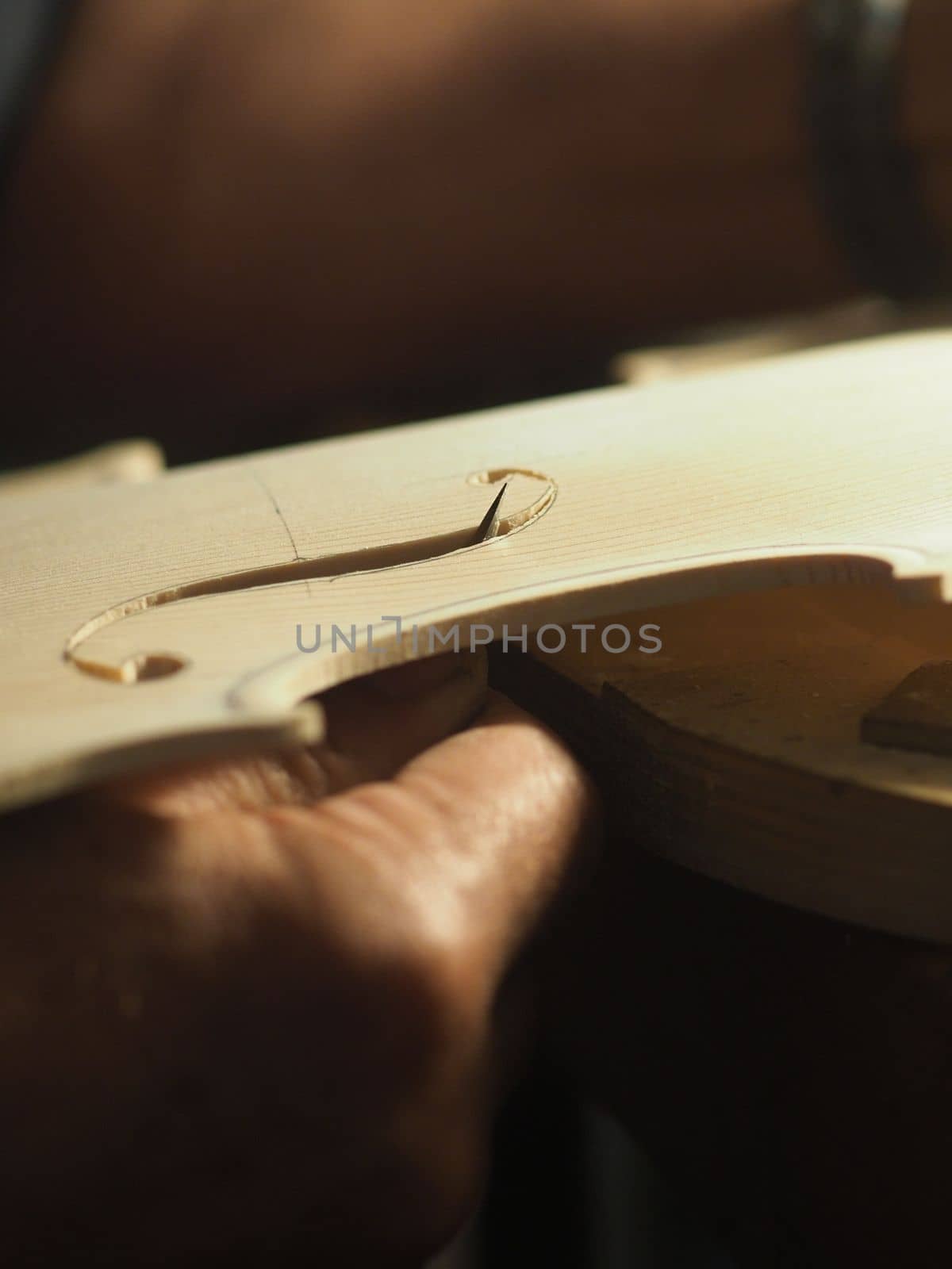 violinmaker cutting and sawing golden period cremonese violin model fholes