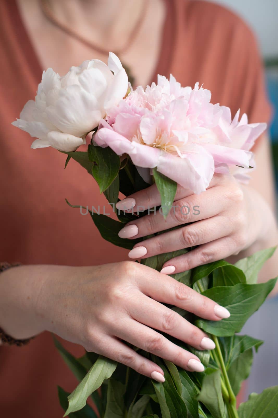 girl's hands with a beautiful pink manicure design, pastel color, gently, flowers in spring. High quality photo