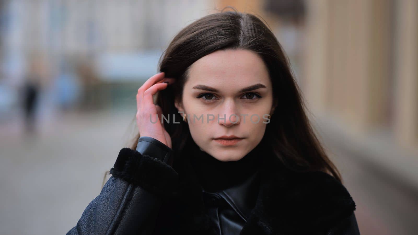 Portrait of a young girl on a city street in early spring