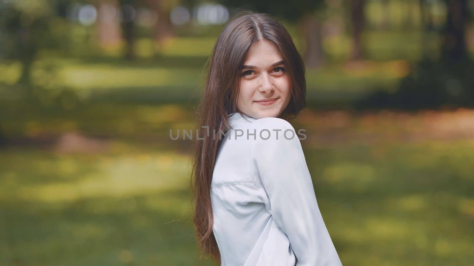 Portrait of a smiling young Georgian girl in a park