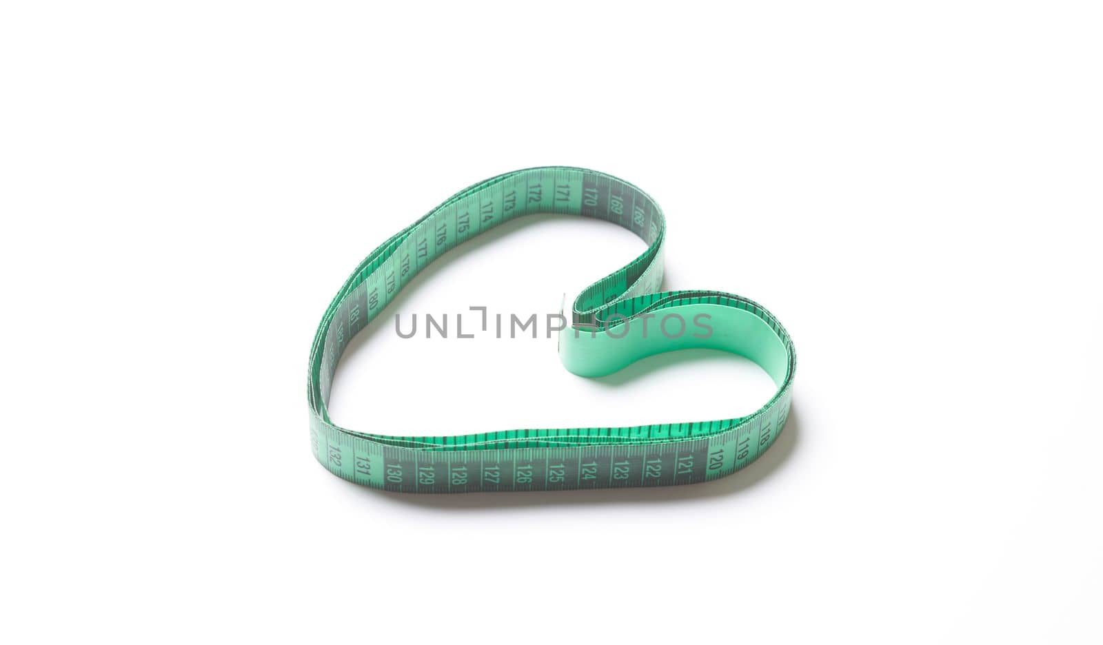 a measuring tape in the shape of a heart on a white background, with copy space for your text stock photo