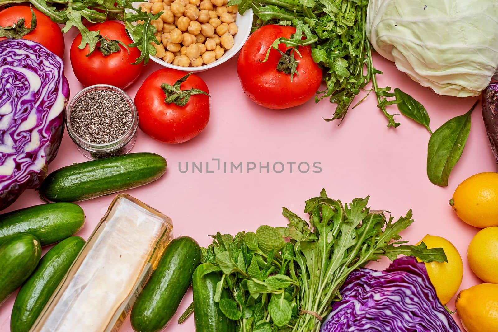 various vegetables and fruits on a pink surface with space for text to be captioned about what you should eat