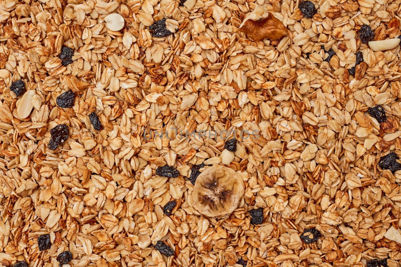 oats on top of a pile of muffins with rait and dried raits in the background