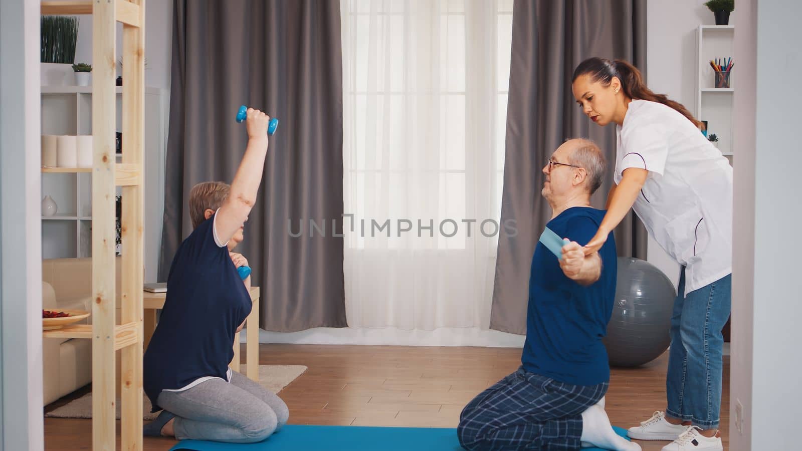 Old people physical therapy with help from physiotherapist. Home assistance, physiotherapy, healthy lifestyle for old person, training and healthy lifestyle