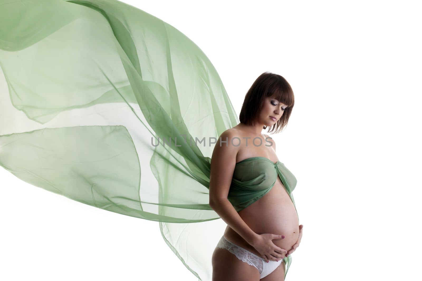 Pretty pregnant woman with green blowing fabric by rivertime