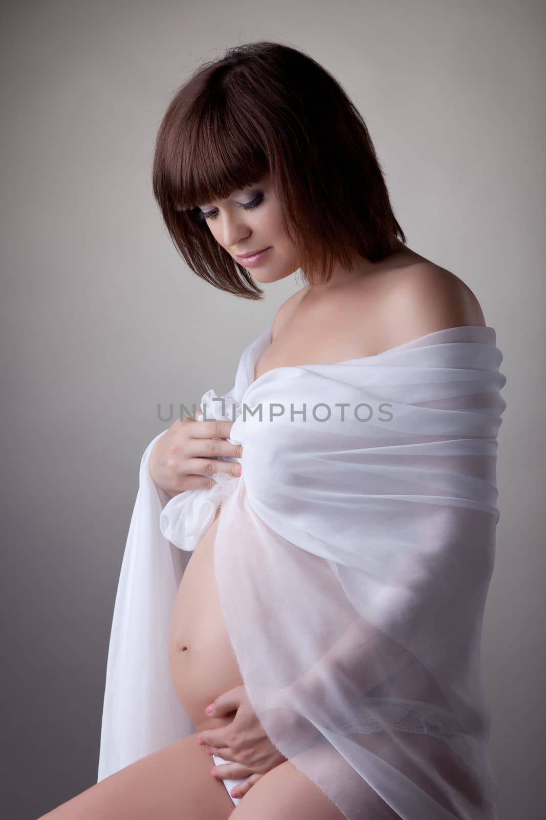 Pretty young pregnant woman Portrait in studio