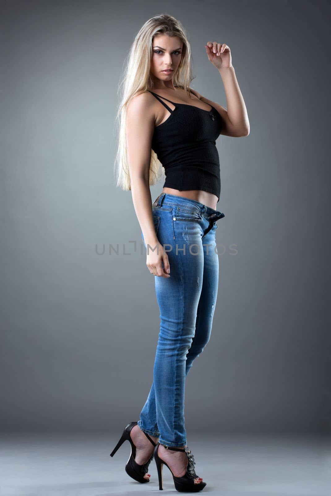 sexy Beautiful woman posing in jeans studio portrait