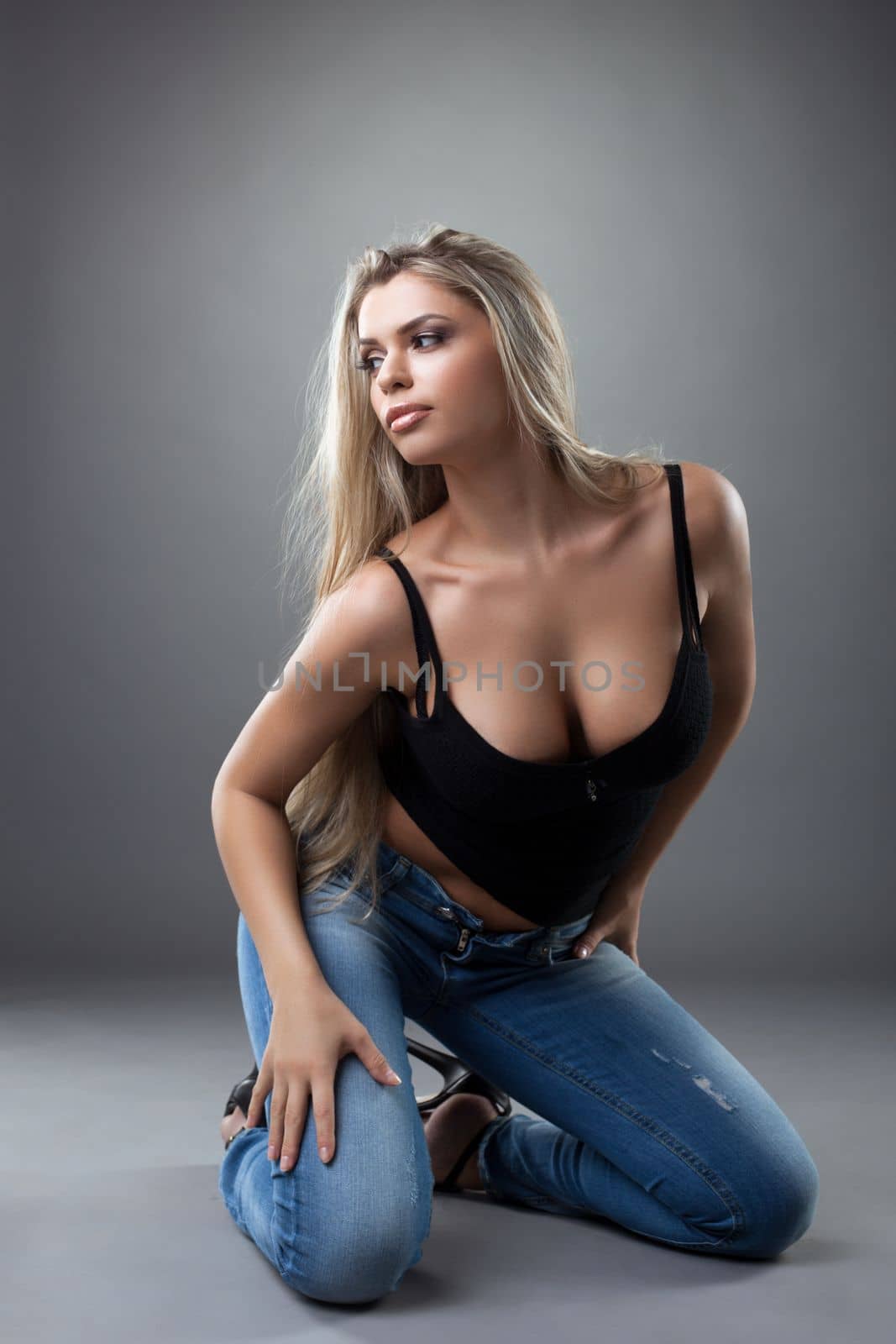 sexy young woman posing in black and jeans by rivertime