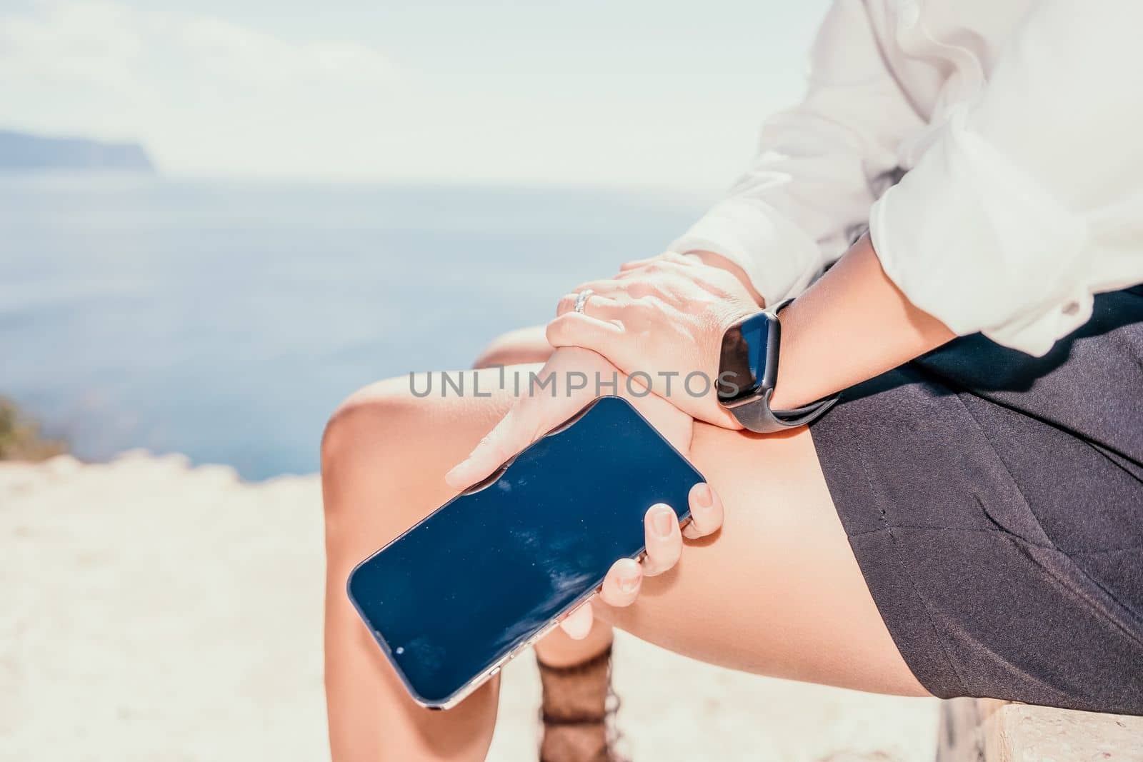 Woman sea laptop. Business woman in yellow hat freelancer with laptop working over blue sea beach. Girl relieves stress from work. Freelance, digital nomad, travel and holidays concept by panophotograph