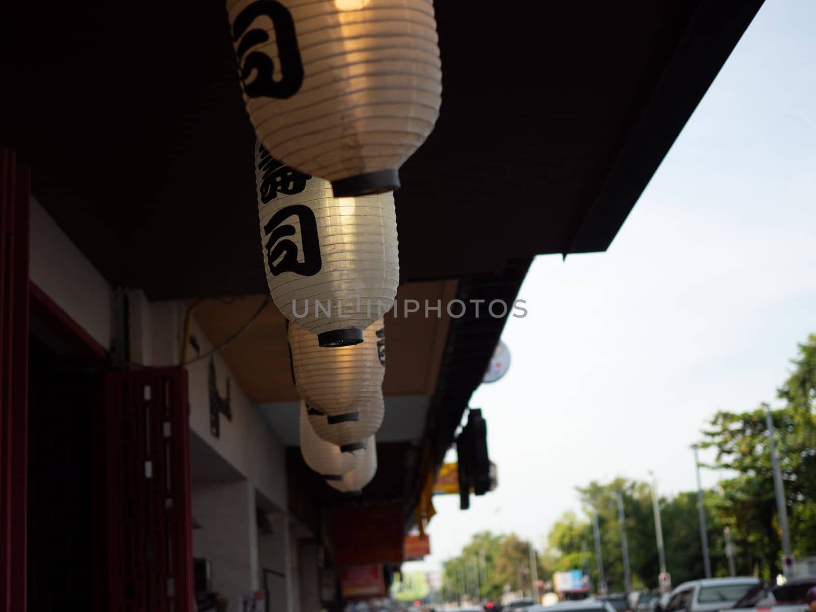 Japanese lantern hung in front of Japanese Restaurant, Japanese text on lantern is "Sushi" Japanese food.