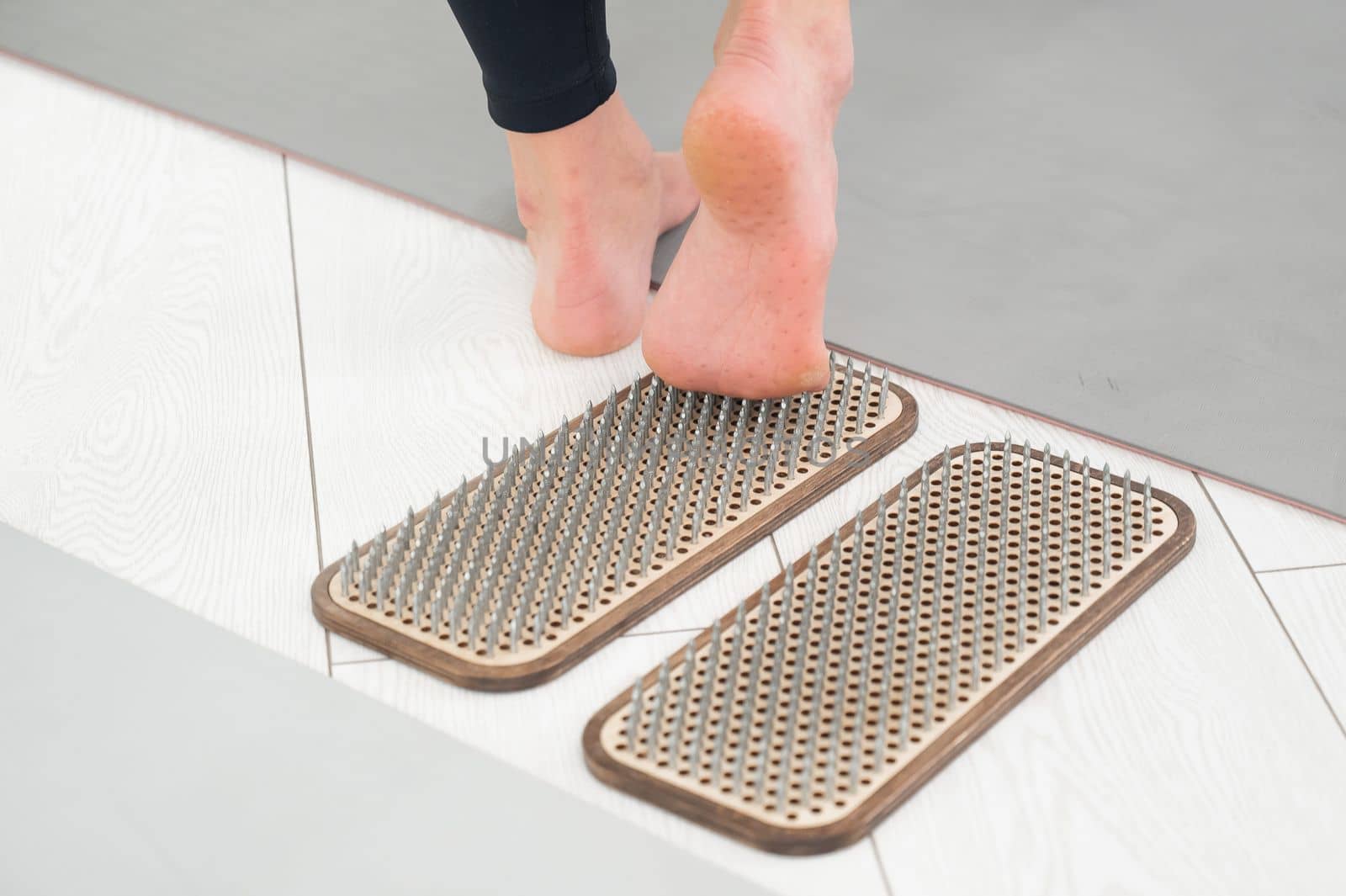 A woman comes down from the sadhu boards. Close-up of feet with prints after nails