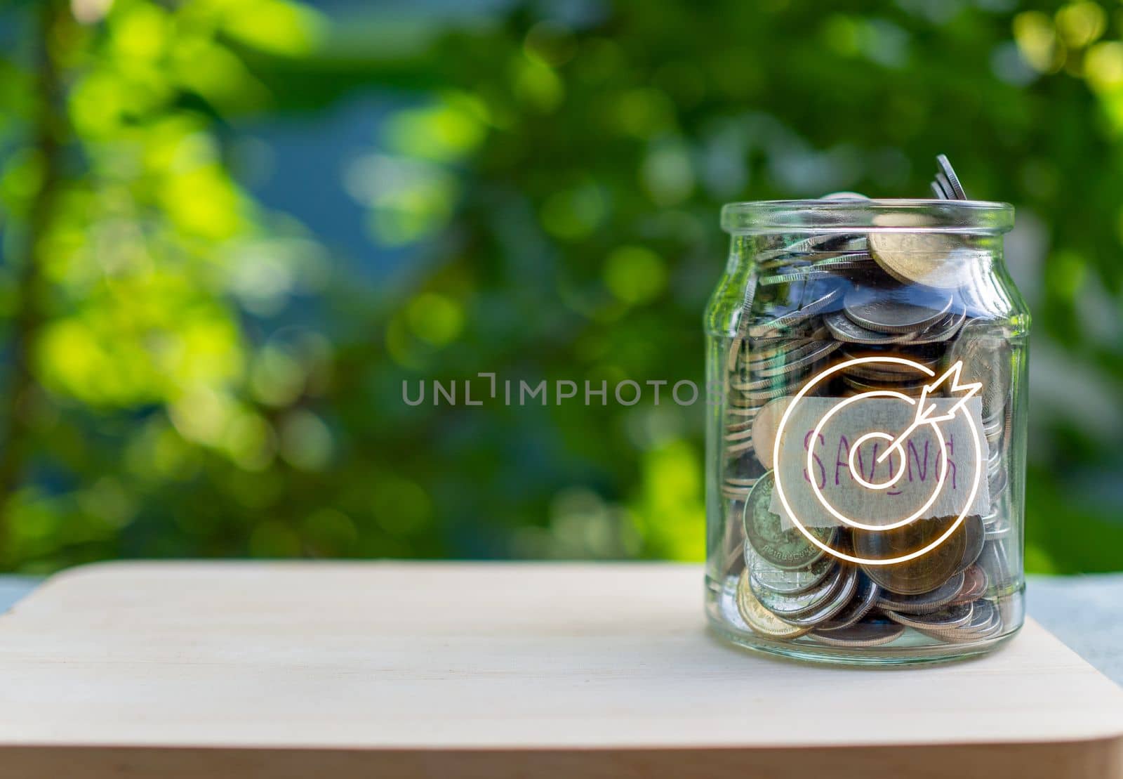 Coins in glass bottles on nature background. The concept of savings and investment.