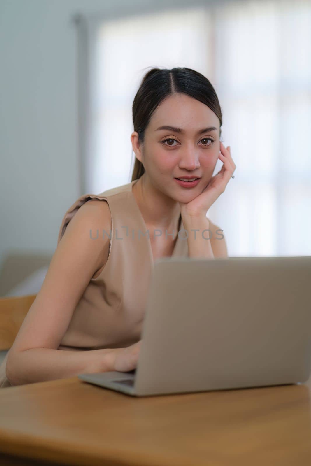 Portrait of Asian woman reading a e book on laptop after get up in morning. Morning lifestyle concept by itchaznong