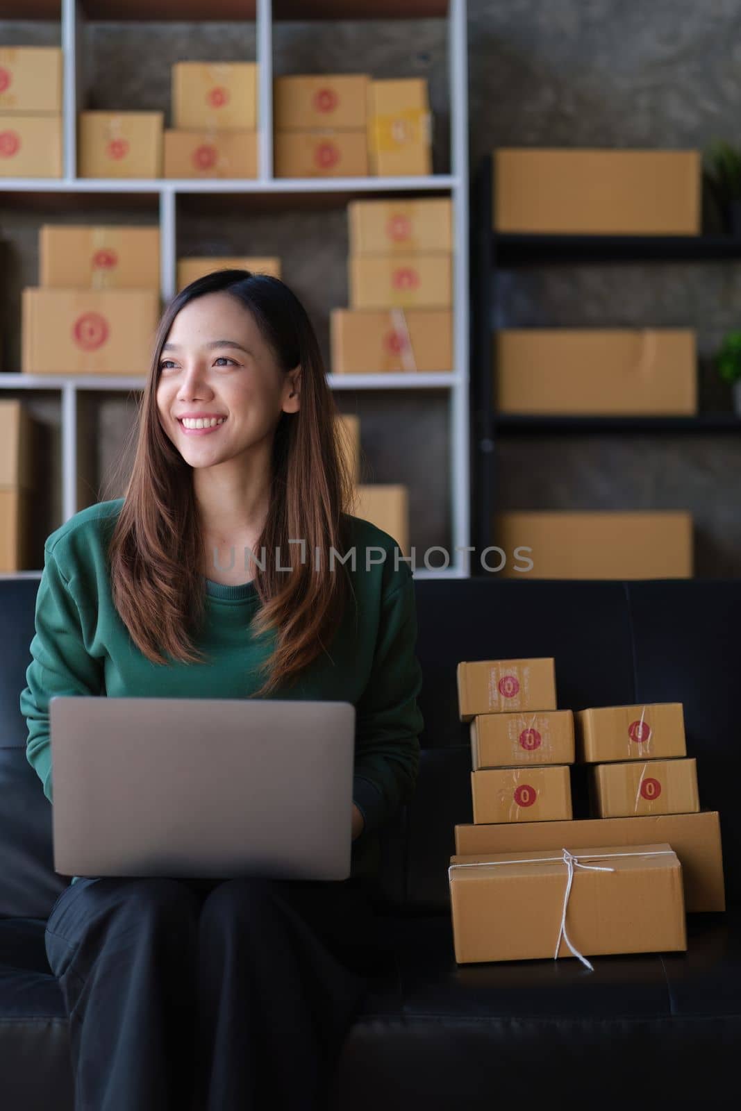 Portrait of Asian young woman SME working with a box at home. small business owner entrepreneur SME and delivery concept.