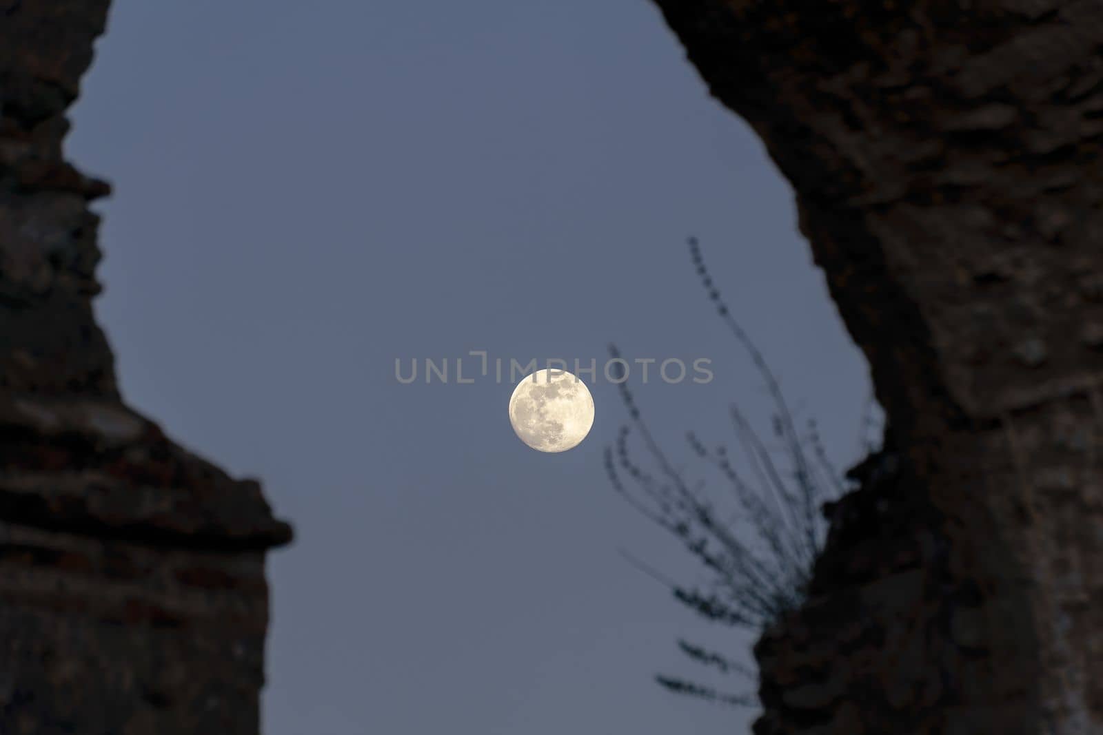 stone arches with full moon in the background by joseantona