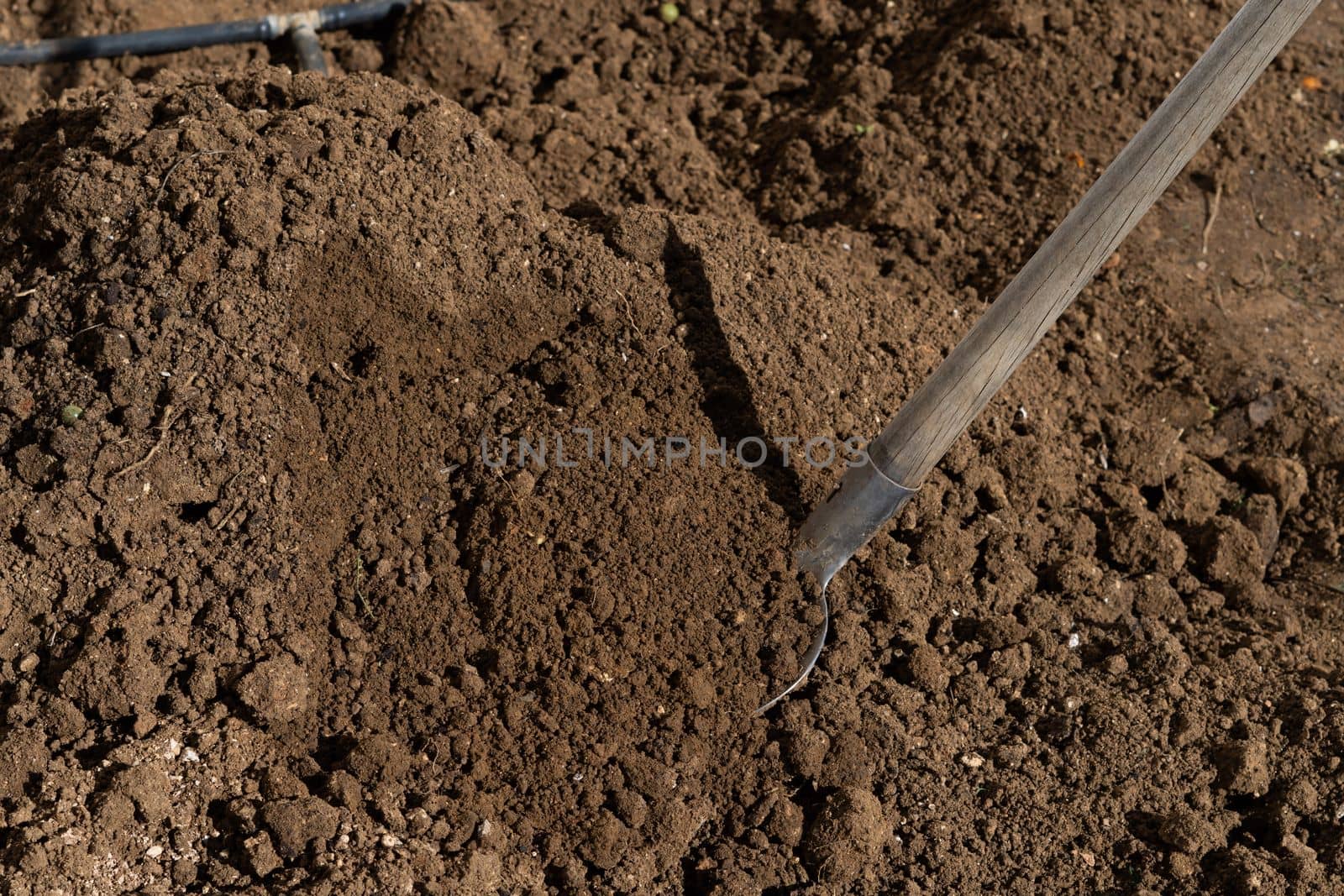 shovel digging the soil of an orchard by joseantona