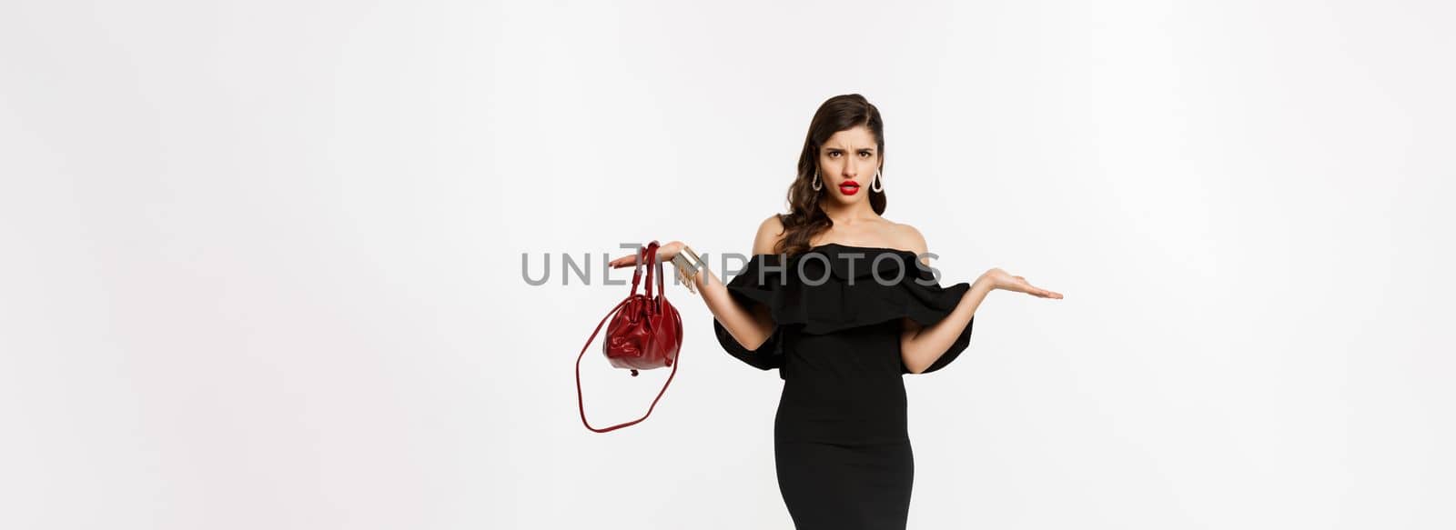 Beauty and fashion concept. Full length of disappointed glamour woman looking confused, raising hands up and staring puzzled, wearing party dress and high heels.