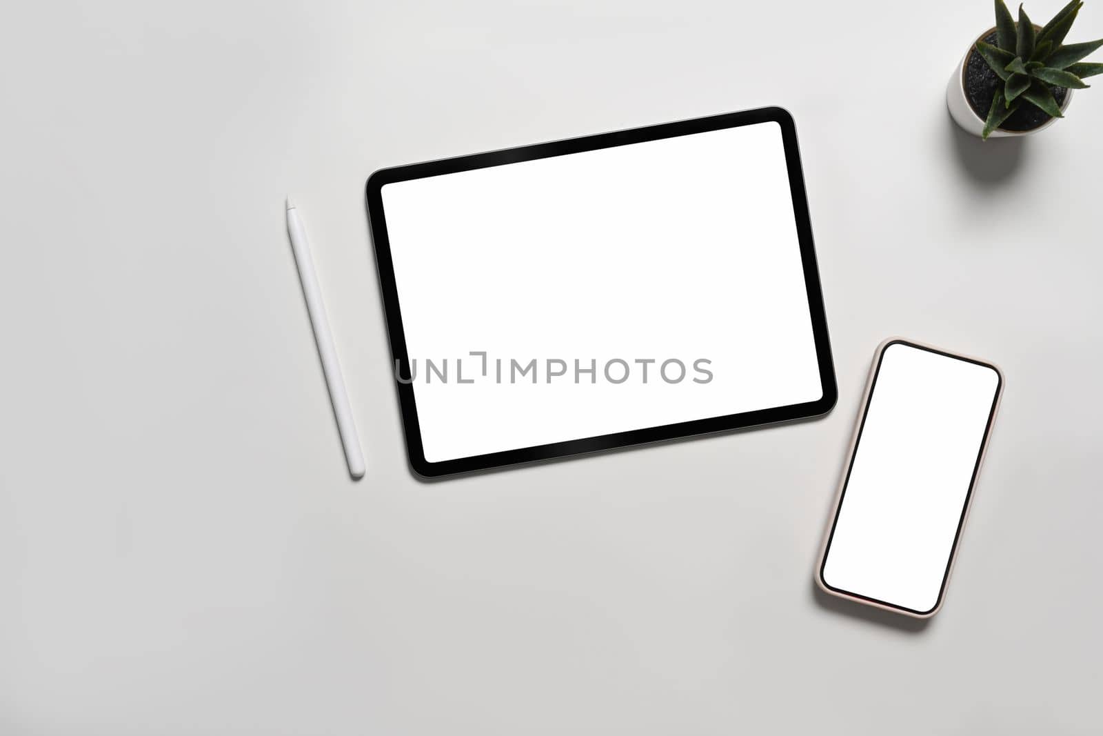 Mock up digital tablet and smart phone with blank screen on white background. by prathanchorruangsak