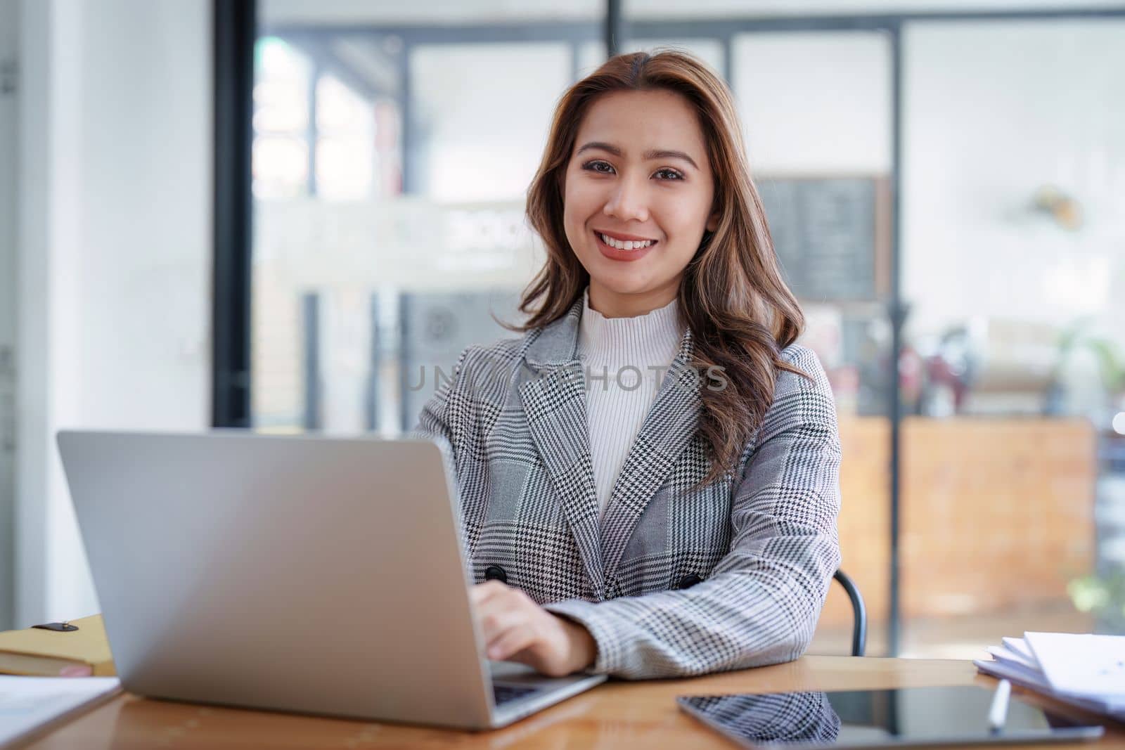 Business woman working at home office and analyze financial report document. Accounting and Finance concept by itchaznong