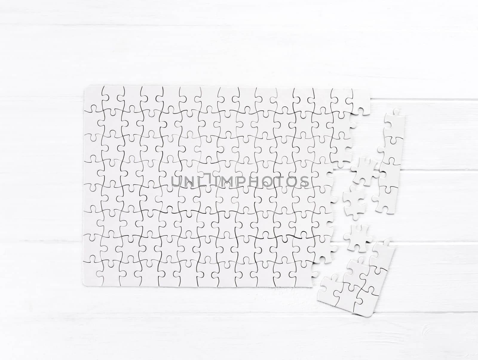 Unfinished bold jigsaw puzzle on wooden table