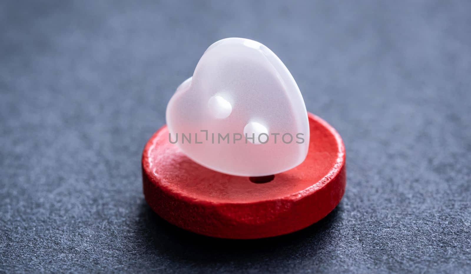 Top view of heart shaped sewing button macro