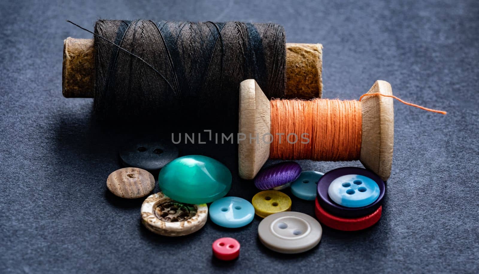 Colorful sewing buttons and thread spools macro