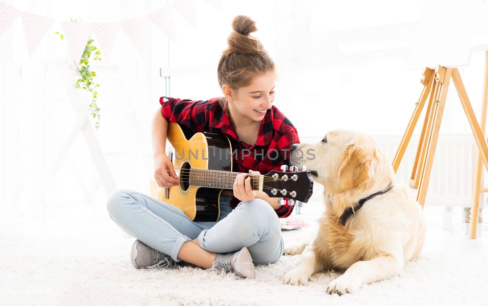 Smiling girl playing guitar to cute dog by GekaSkr