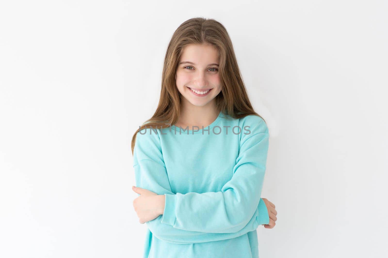 Portrait of smiling teenage girl on a wall background