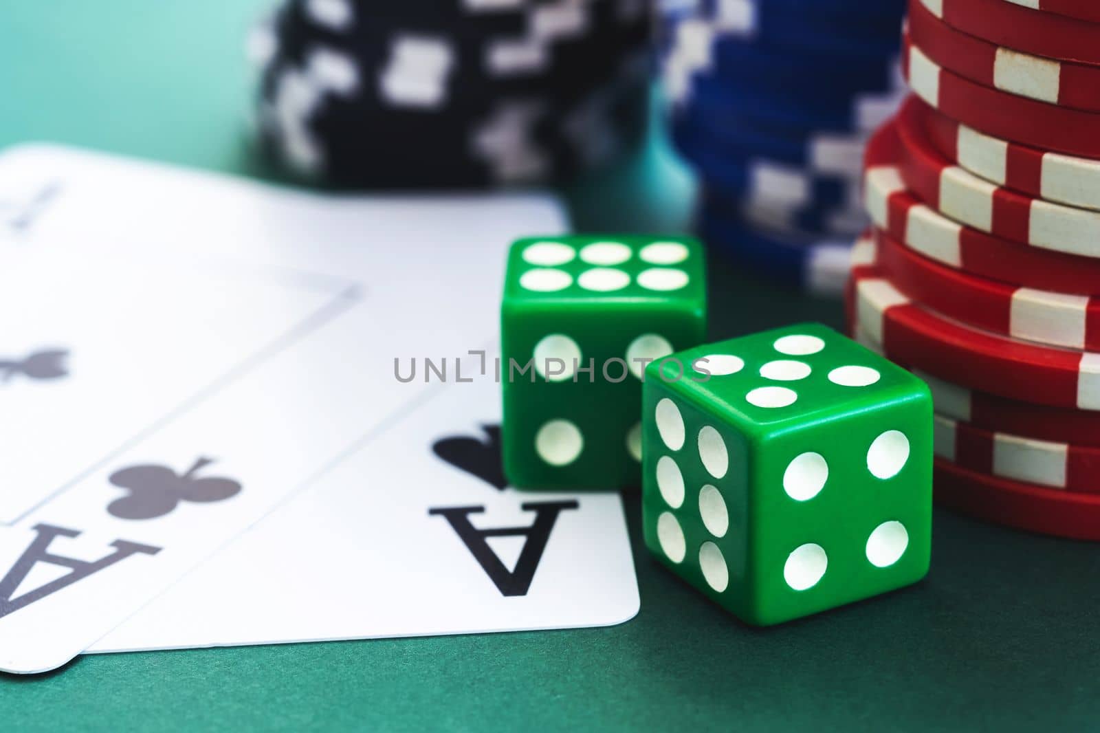 Dice, cards and chips for poker on table, close up view