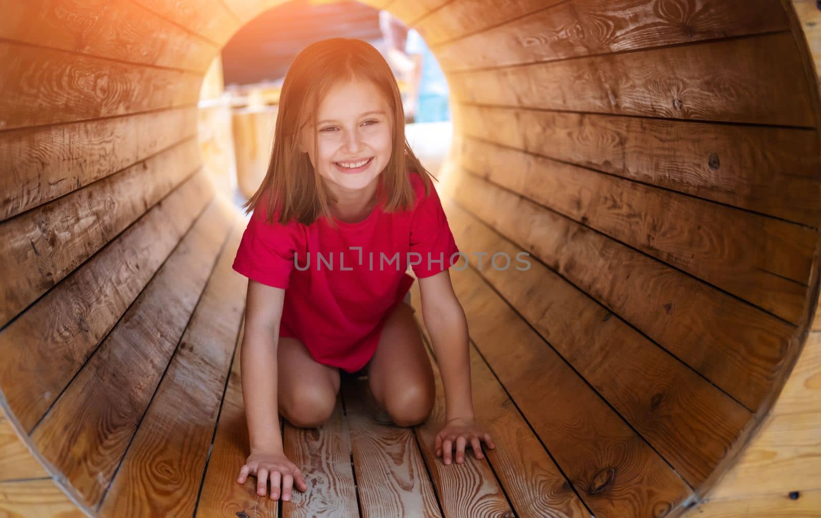 Little girl crawling inside wooden pipe by GekaSkr