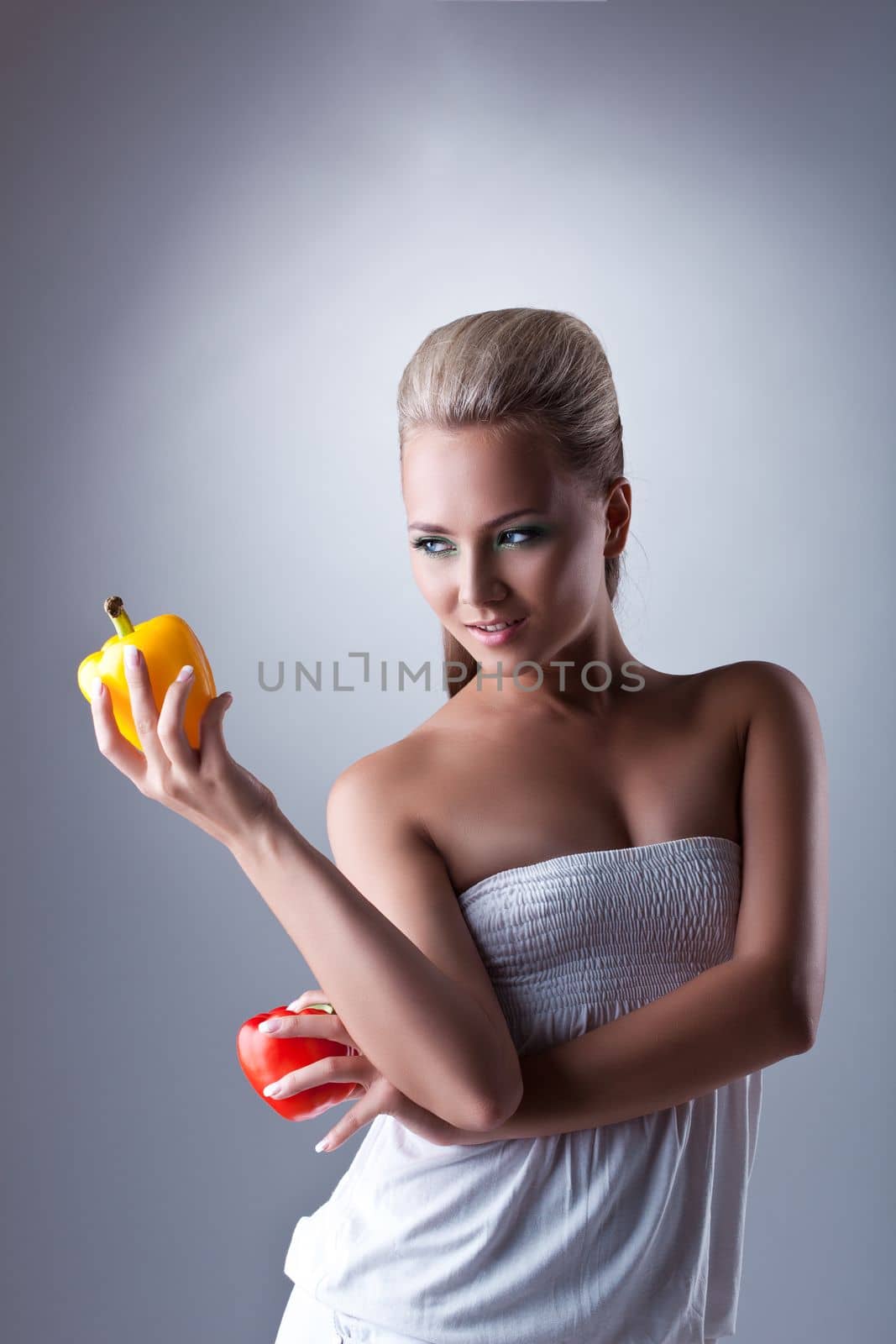 Beauty young woman hold orange and red bulgarian pepper