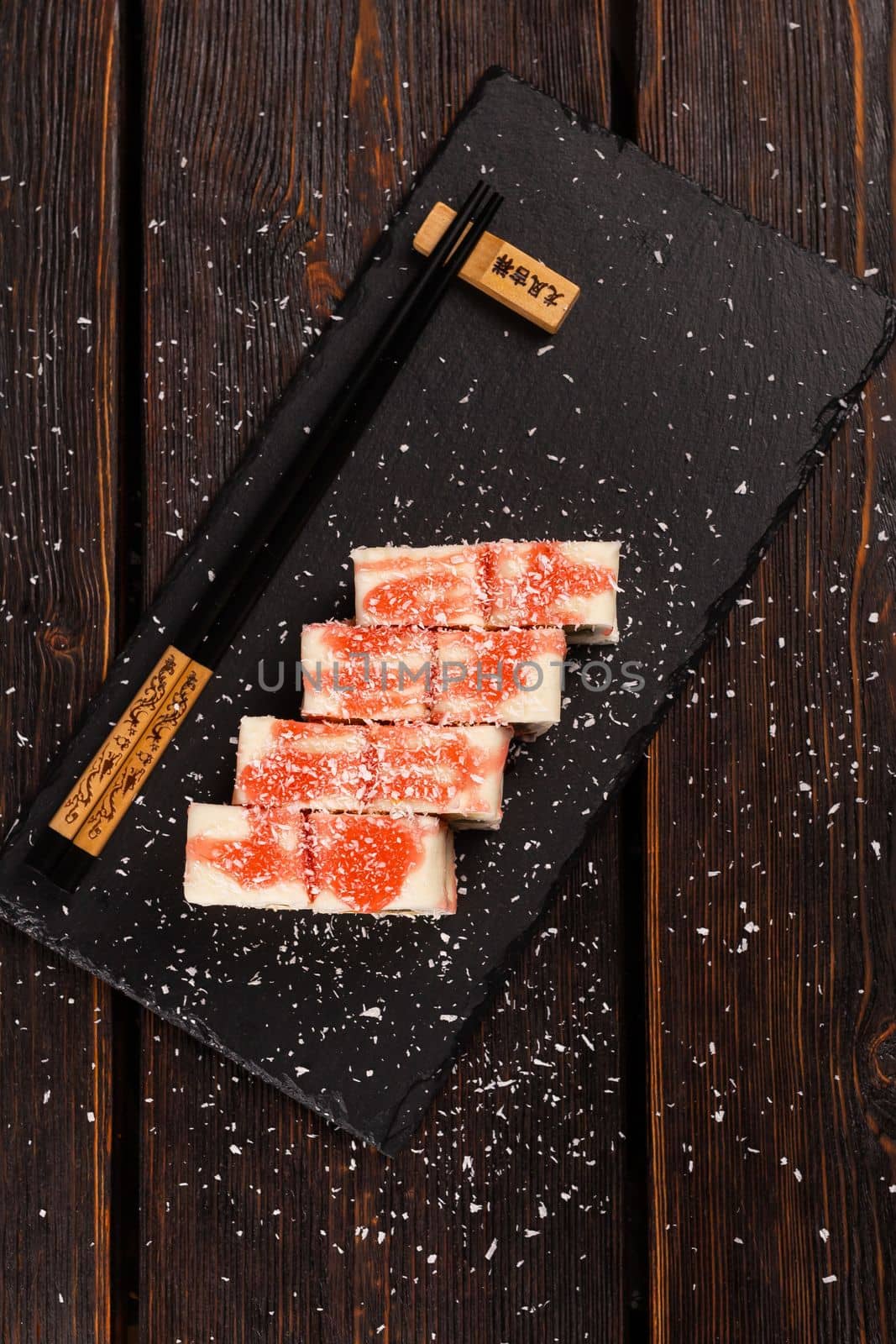 Asian sweet dessert maki sushi top view - Roll with fruits and cream cheese with coconut flakes and topping by Satura86
