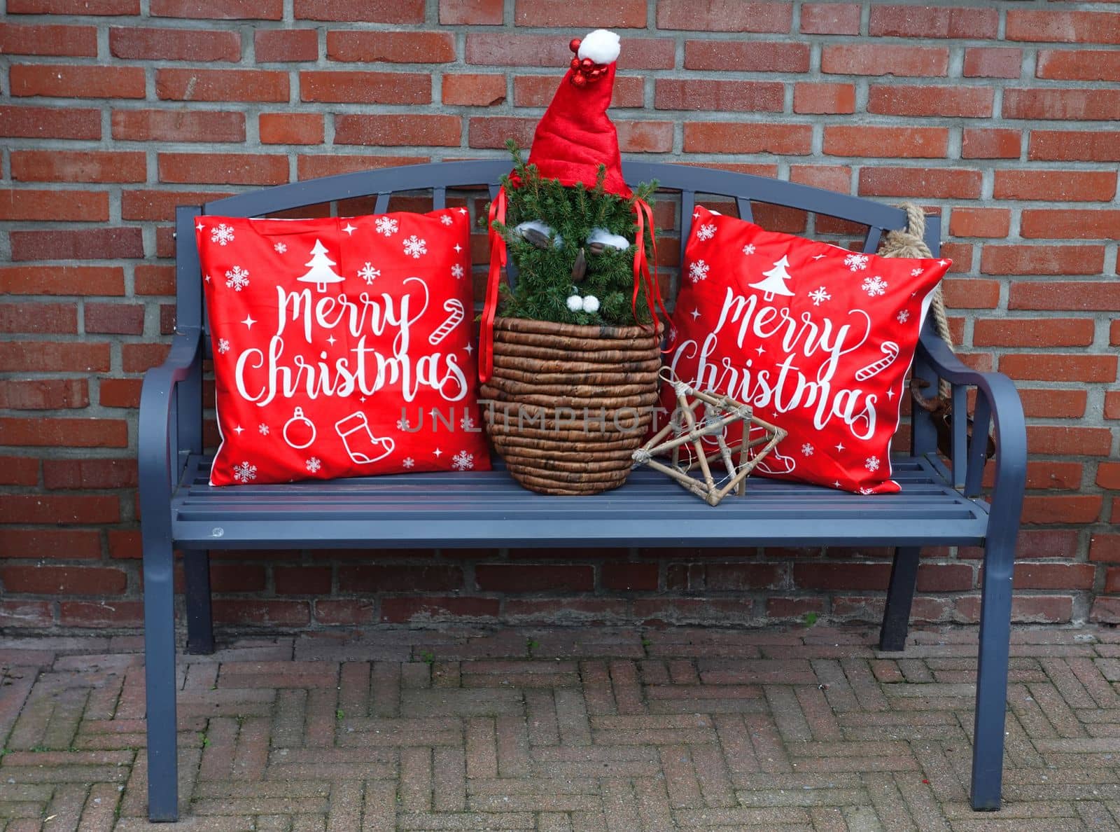 Blue bench with merry Christmas cushions on it