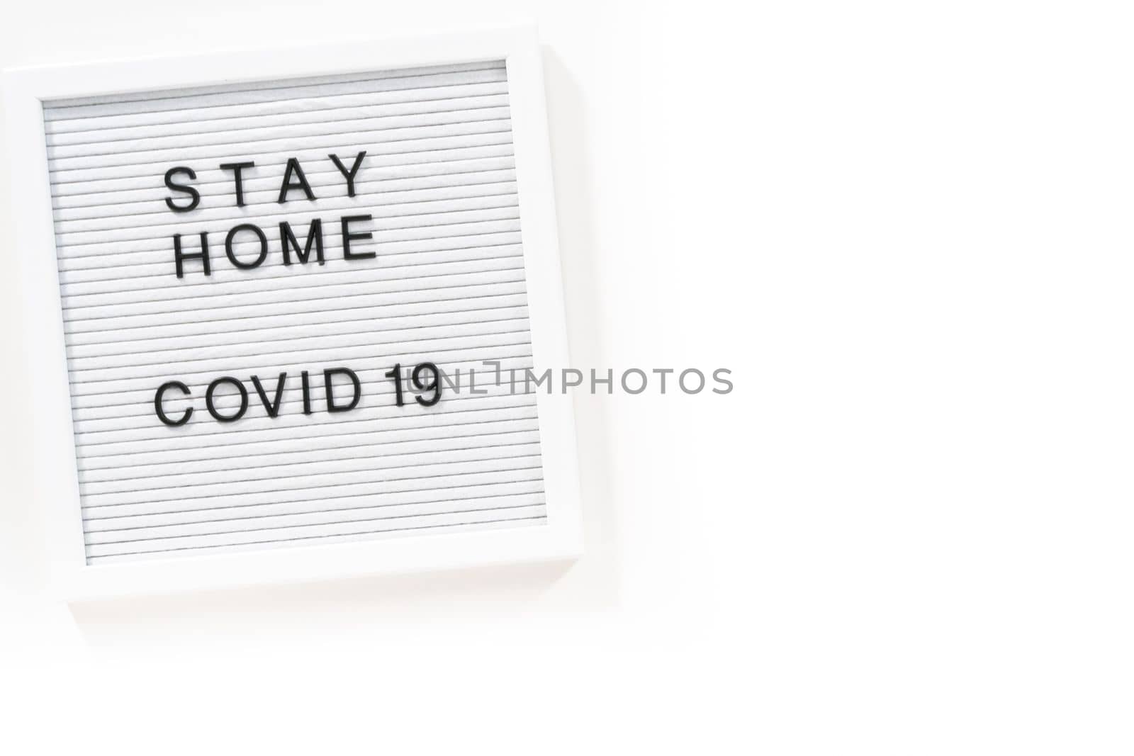 STAY HOME and COVID-19 sign on message board.