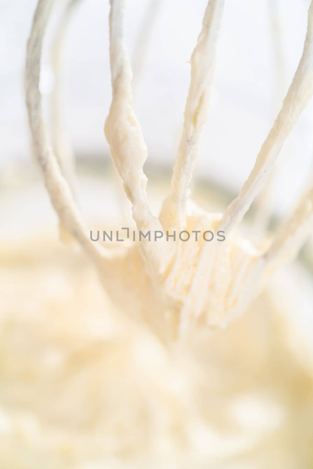 Whipping white ganache in kitchen mixer to make the white chocolate ganache frosting.