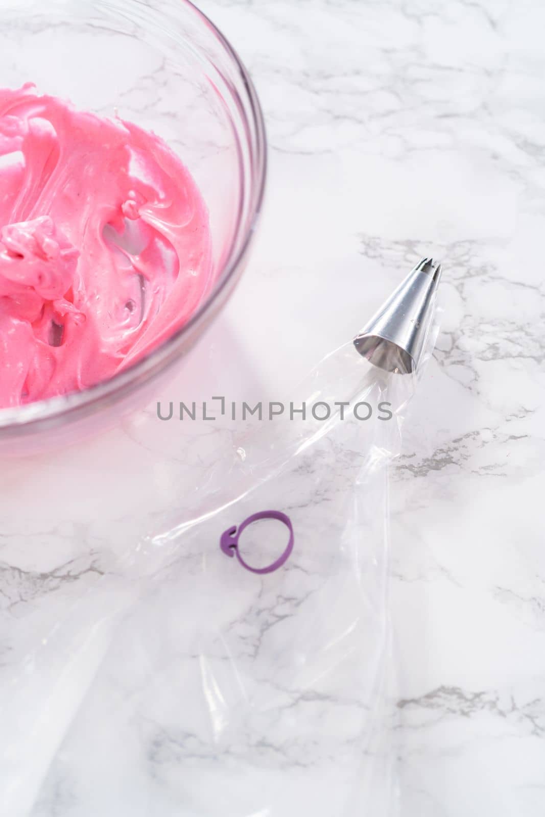 Filling piping bags with meringue to pipe Easter meringue cookies.