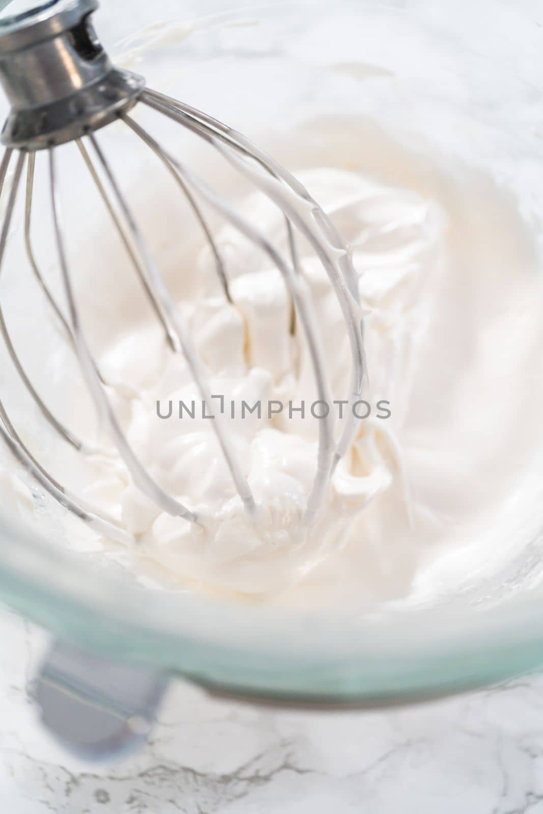 Mixing ingredients in kitchen mixer to bake Easter meringue cookies.