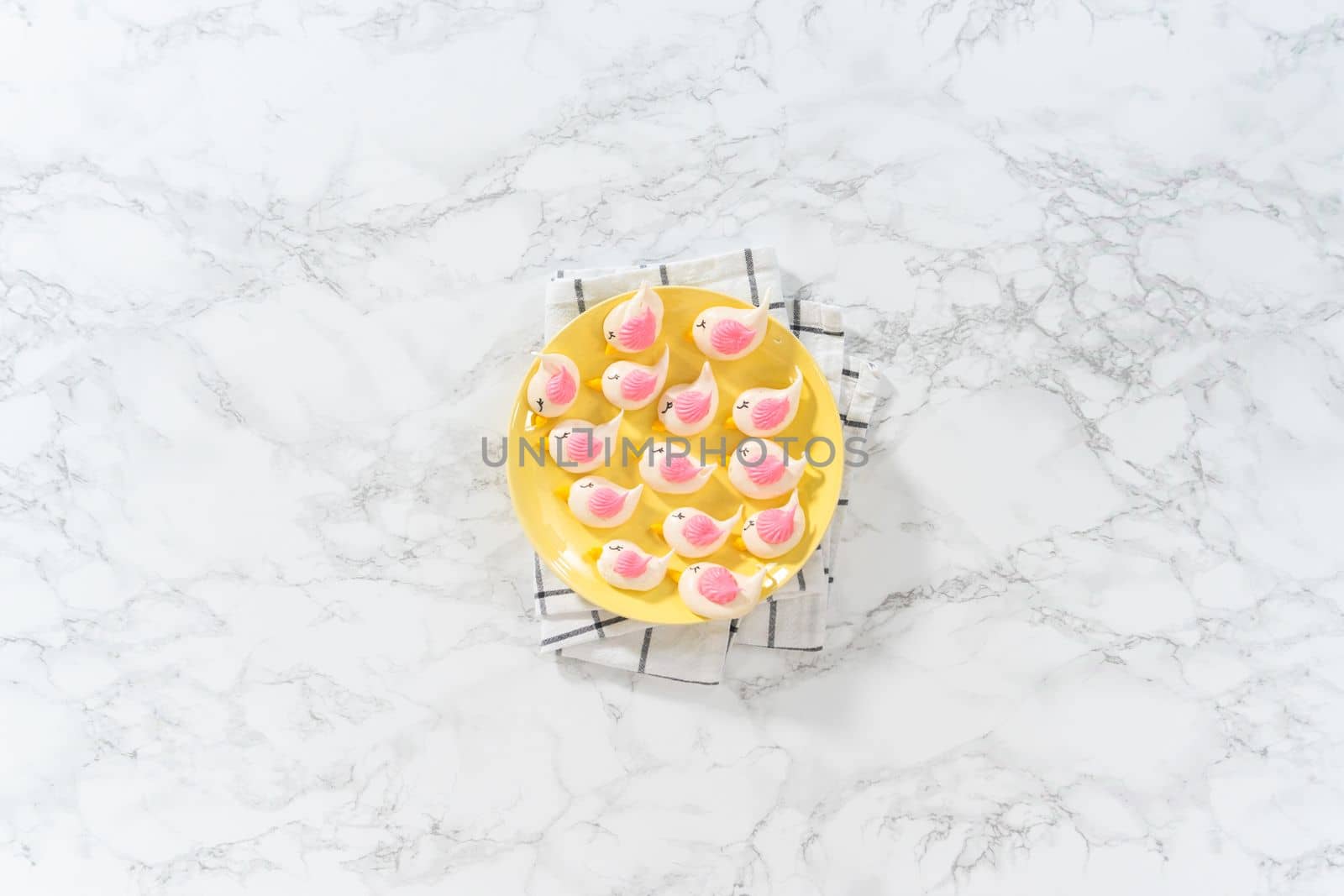 Freshly baked Easter meringue cookies in the shape of birds.