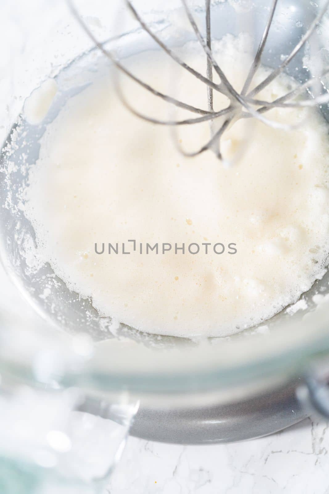 Mixing ingredients in kitchen mixer to bake Easter meringue cookies.
