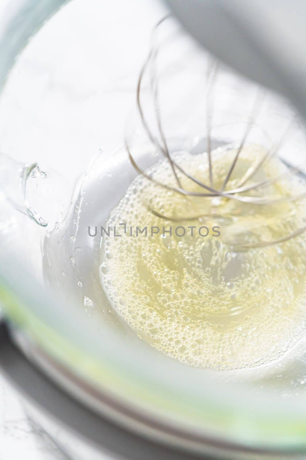 Mixing ingredients in kitchen mixer to bake Easter meringue cookies.
