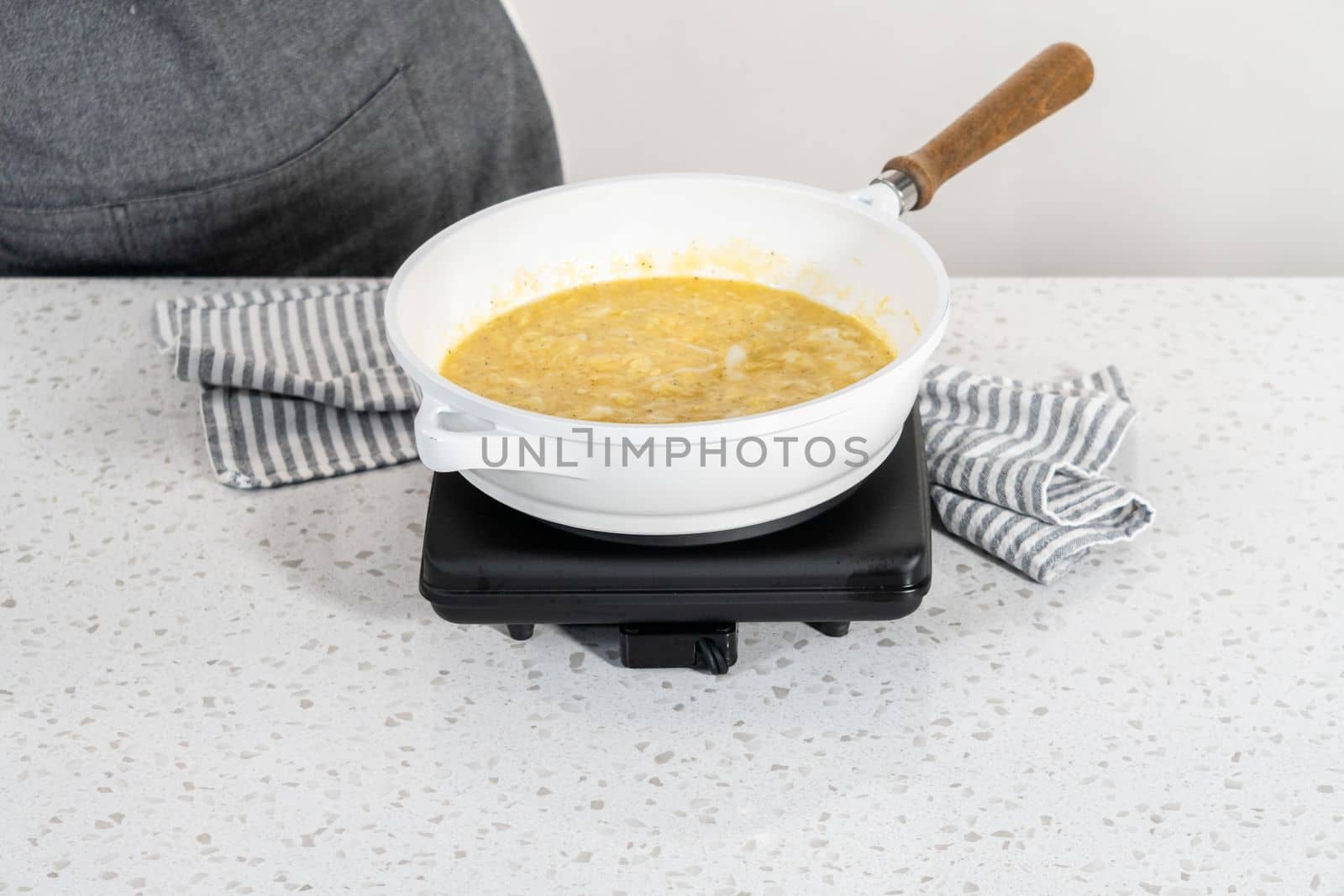Frying eggs on a nonstick frying pan to make breakfast empanadas with eggs and sweet potato.