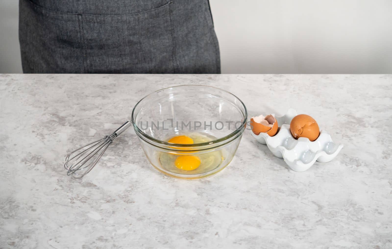 Measured ingredients in glass mixing bowls to bake eggnog scones.