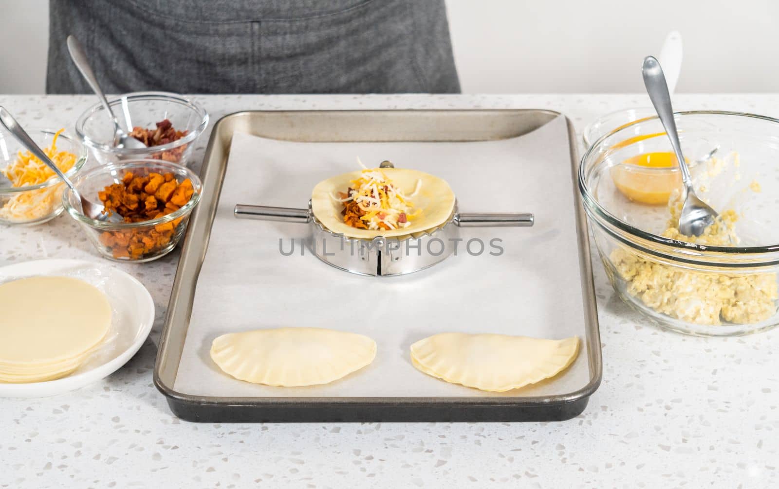 Filling empanada dough with egg filling to make breakfast empanadas with eggs and sweet potato.