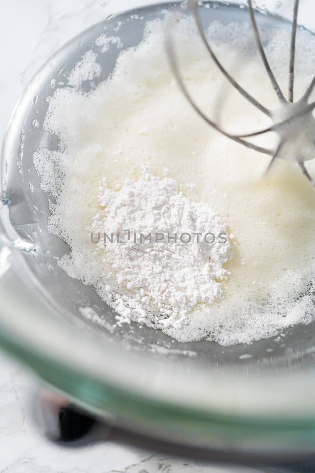 Mixing ingredients in kitchen mixer to bake Easter meringue cookies.