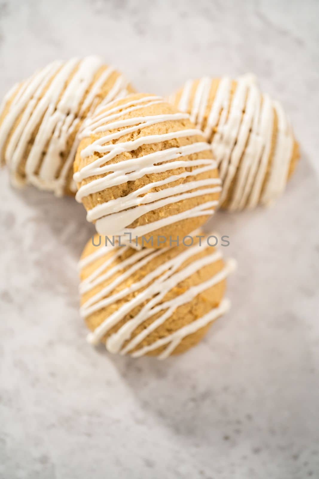 Freshly baked chocolate cookies with eggnog scones with a white chocolate drizzle on top.
