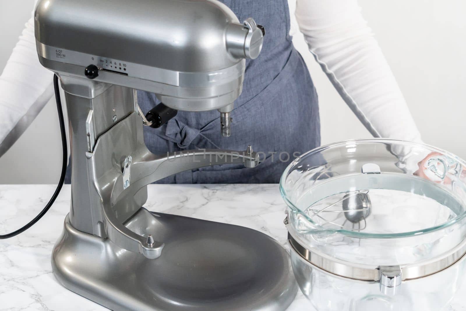 Whipping white ganache in kitchen mixer to make the white chocolate ganache frosting.