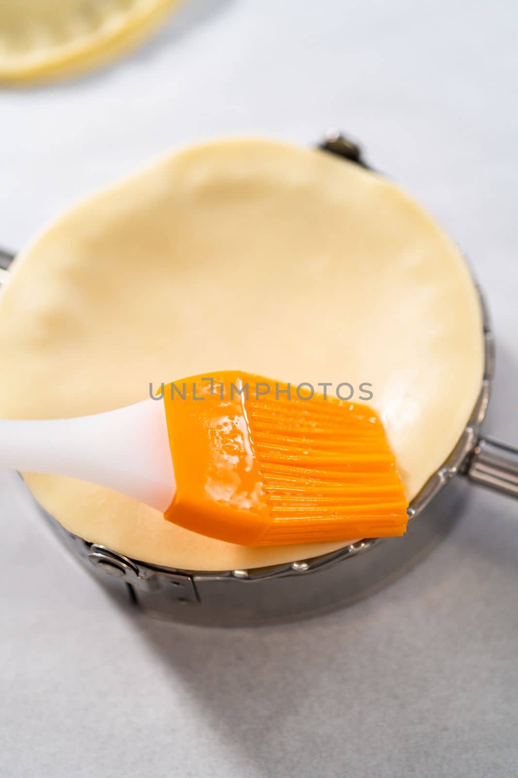 Filling empanada dough with blueberry pie filling to make sweet empanadas with blueberries.